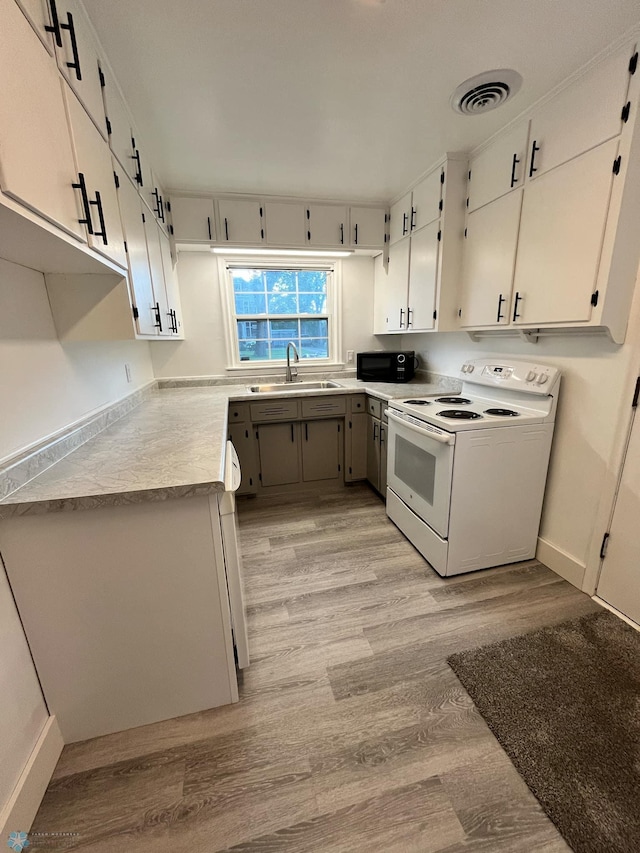 kitchen with light hardwood / wood-style floors, white electric range, sink, and white cabinets