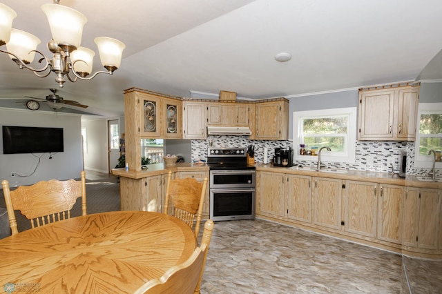 kitchen with sink, tasteful backsplash, range with two ovens, and ceiling fan with notable chandelier