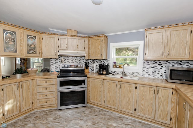 kitchen featuring light brown cabinetry, light tile patterned floors, appliances with stainless steel finishes, sink, and tasteful backsplash