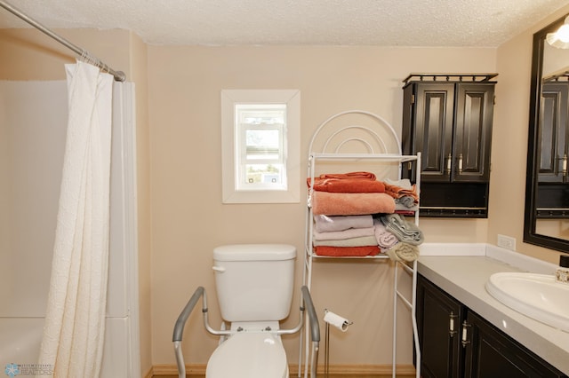 full bathroom with shower / bath combo with shower curtain, a textured ceiling, vanity, and toilet