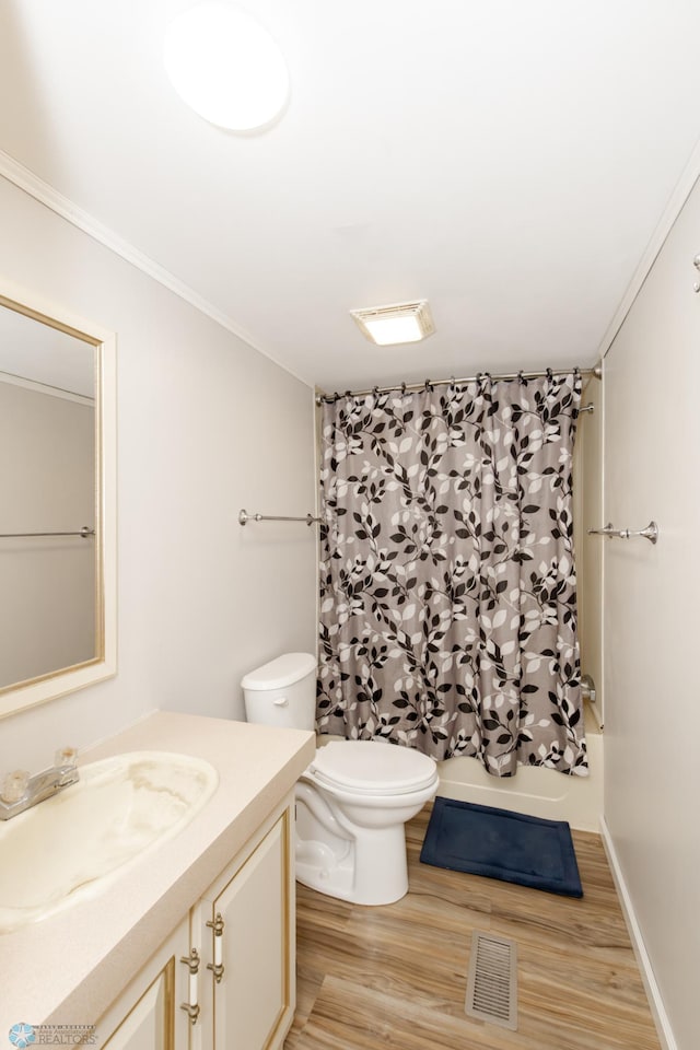 full bathroom featuring toilet, ornamental molding, vanity, and hardwood / wood-style floors