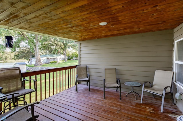 wooden terrace with a yard