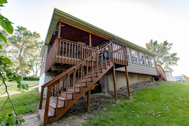 back of house with a lawn and a deck