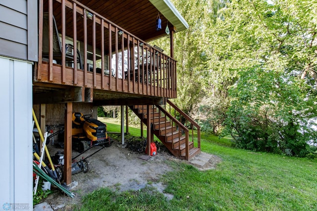 exterior space featuring a wooden deck and a lawn