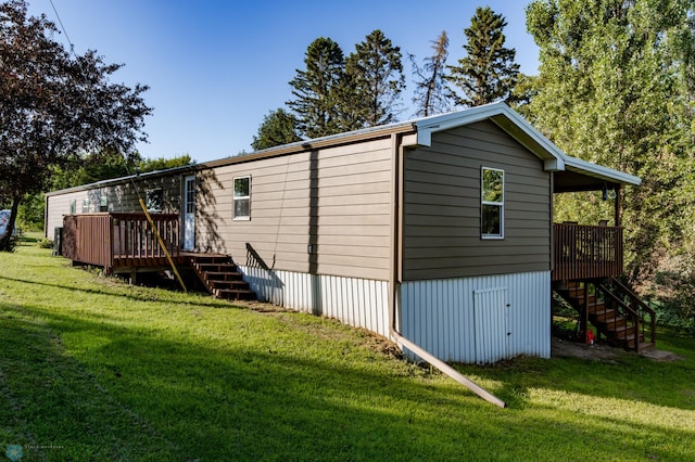 view of side of property featuring a wooden deck and a lawn