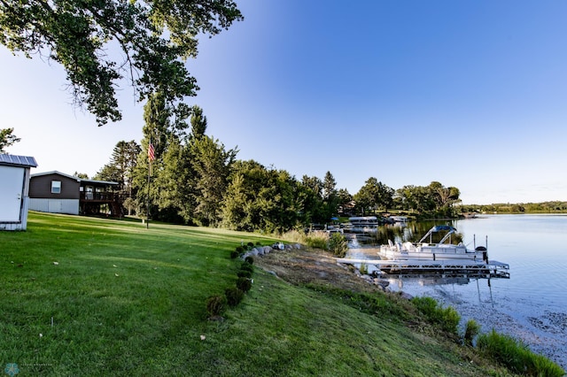 dock area featuring a water view and a lawn