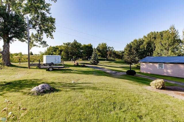 view of yard featuring a garage and an outdoor structure