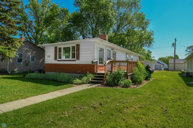 view of front facade featuring a front yard and a deck