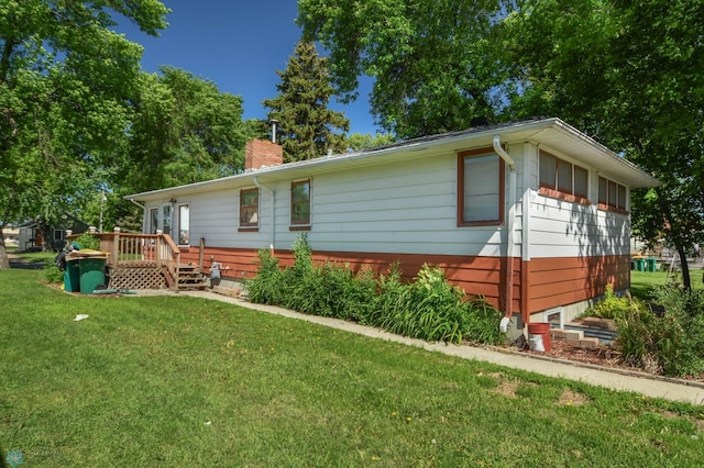 exterior space featuring a wooden deck and a yard