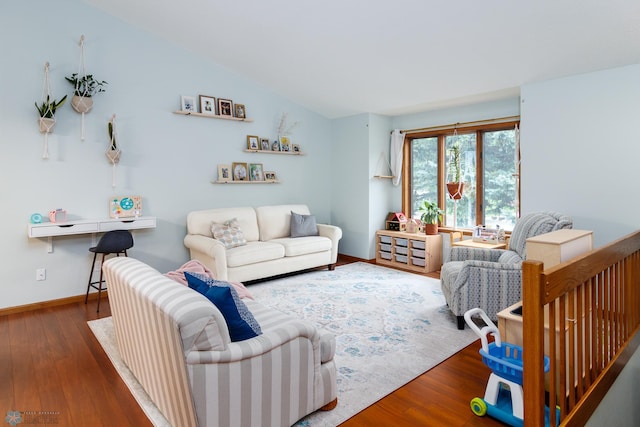 living room featuring lofted ceiling and hardwood / wood-style flooring