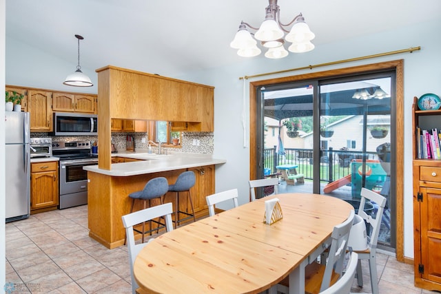 dining space featuring light tile patterned flooring, a notable chandelier, and lofted ceiling