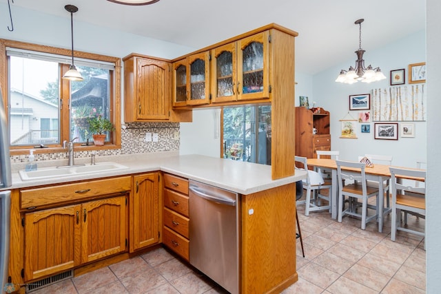 kitchen with sink, dishwasher, kitchen peninsula, and backsplash