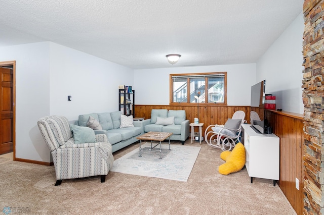 living room featuring a textured ceiling and light carpet