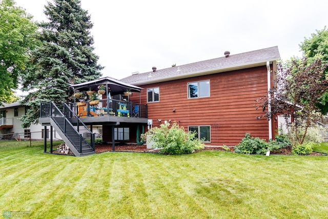 rear view of property with a wooden deck and a yard