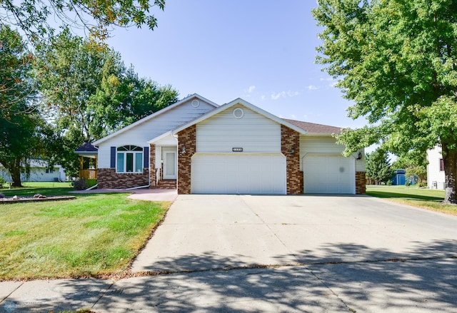 ranch-style home featuring a garage and a front lawn