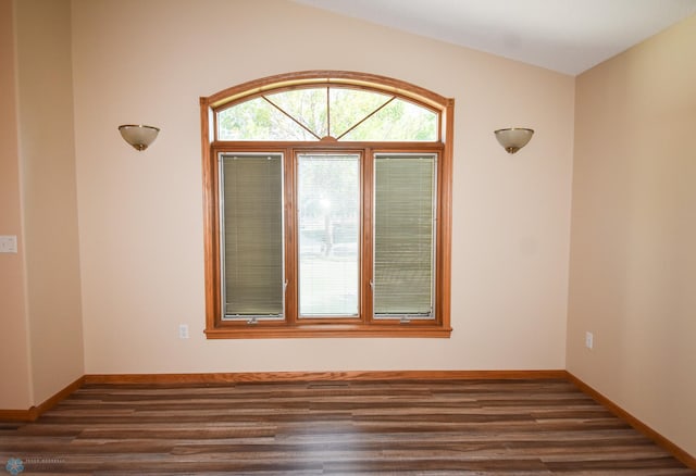 empty room with dark hardwood / wood-style floors