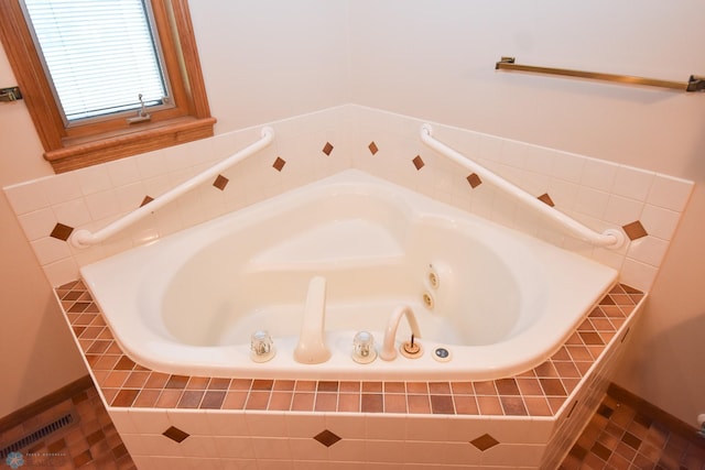 bathroom with a relaxing tiled tub