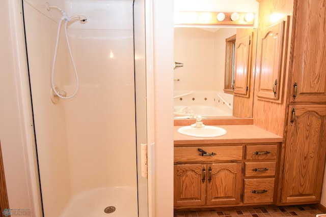 bathroom with walk in shower and vanity