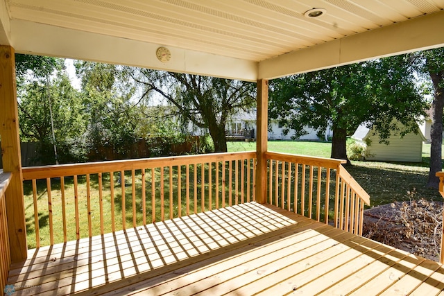 wooden terrace featuring a yard