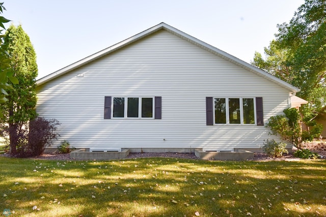 view of side of home featuring a yard