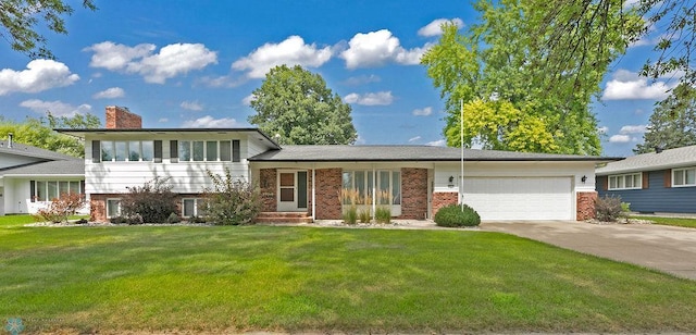 split level home featuring a front lawn and a garage