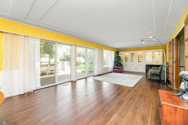 living room featuring dark hardwood / wood-style floors and a textured ceiling