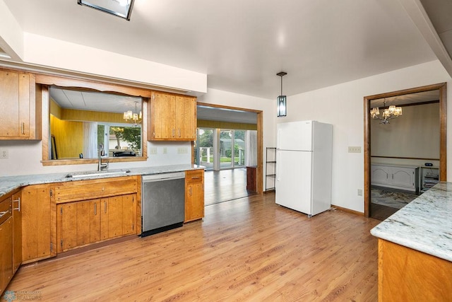 kitchen featuring white fridge, stainless steel dishwasher, an inviting chandelier, and light hardwood / wood-style flooring