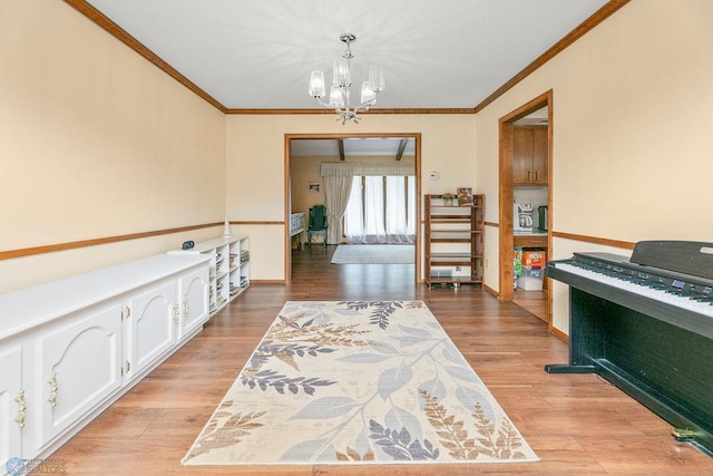 interior space featuring light wood-type flooring, ornamental molding, and a chandelier