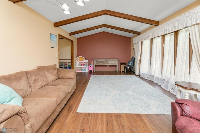 living room featuring hardwood / wood-style floors, an inviting chandelier, and lofted ceiling with beams