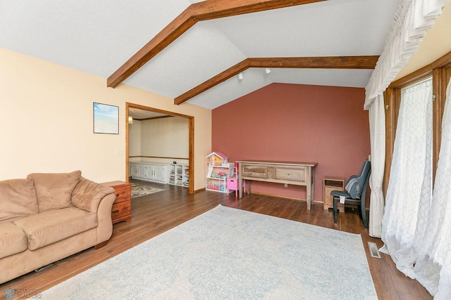 interior space with dark hardwood / wood-style floors and lofted ceiling with beams