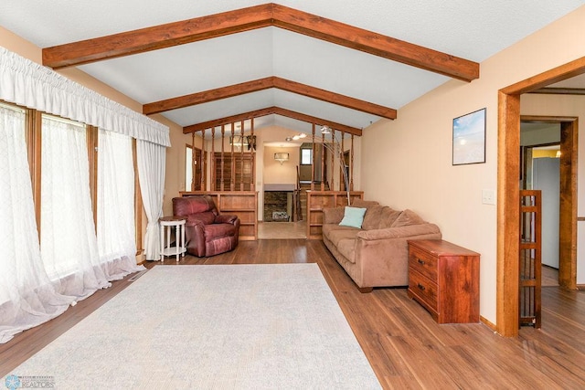 living room with hardwood / wood-style floors and lofted ceiling with beams