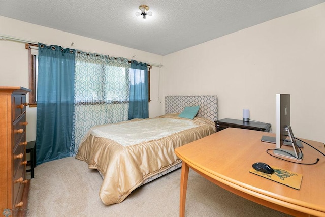 bedroom with carpet and a textured ceiling