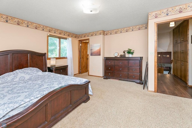 carpeted bedroom with a textured ceiling