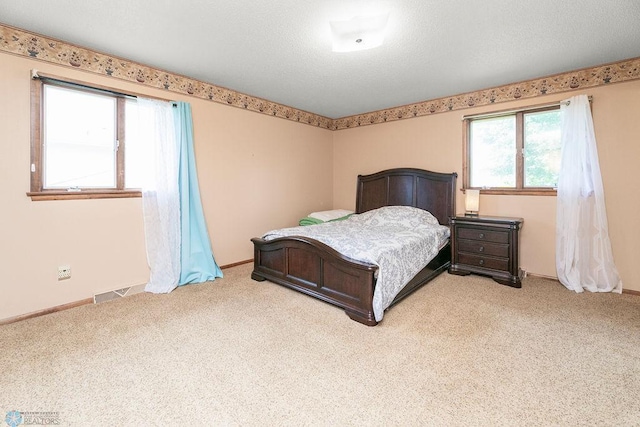 bedroom featuring light colored carpet