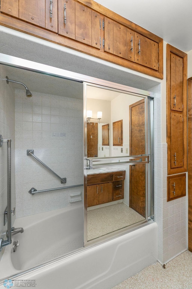 bathroom with enclosed tub / shower combo and vanity