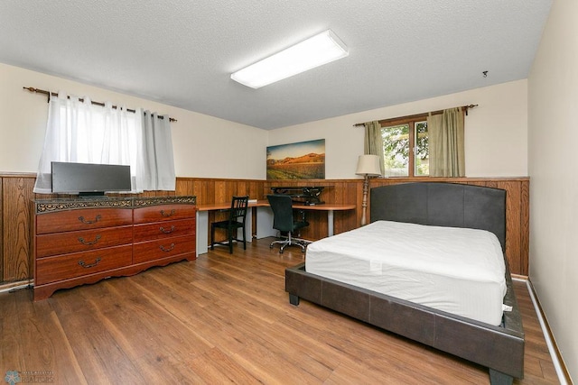 bedroom featuring hardwood / wood-style flooring and a textured ceiling