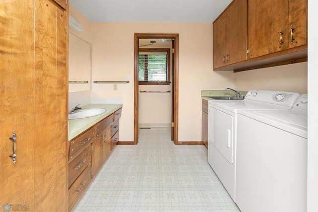 washroom featuring sink, cabinets, light tile patterned flooring, and independent washer and dryer