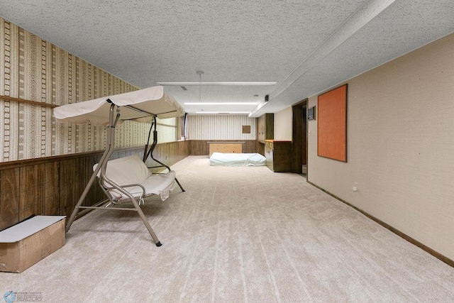 interior space with a textured ceiling and carpet flooring