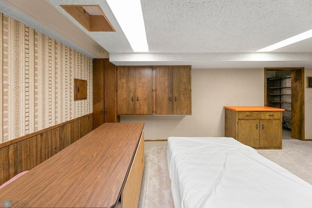 carpeted bedroom featuring a textured ceiling