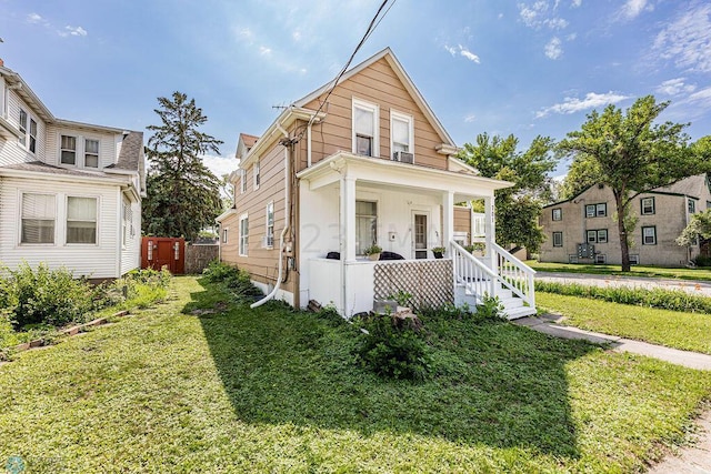 bungalow with a front lawn and covered porch