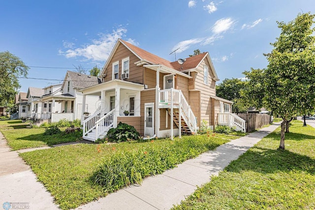 view of front of home with covered porch and a front yard