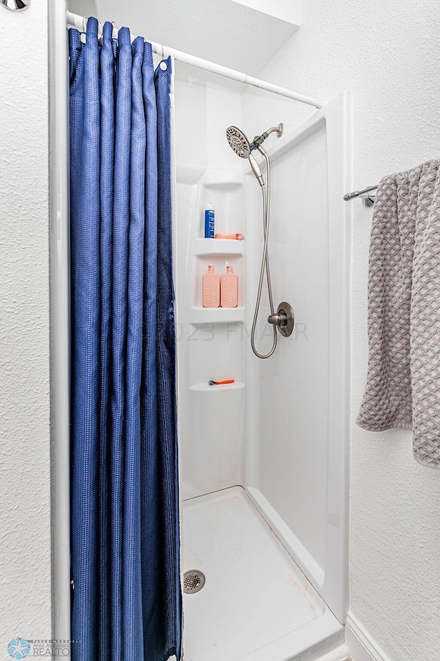 bathroom with a shower with shower curtain