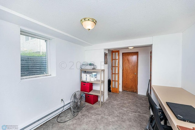 home office with a textured ceiling and a baseboard radiator