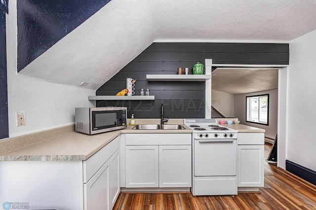 kitchen with white range with gas cooktop, a textured ceiling, hardwood / wood-style floors, vaulted ceiling, and sink