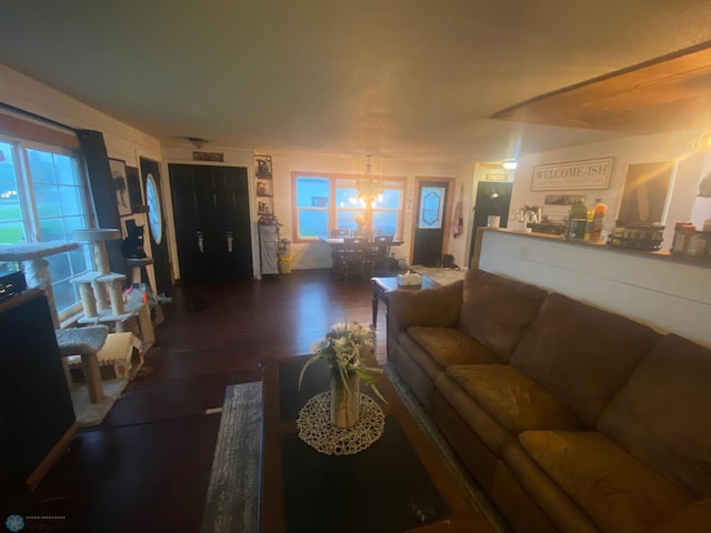 living room featuring a chandelier and dark hardwood / wood-style floors