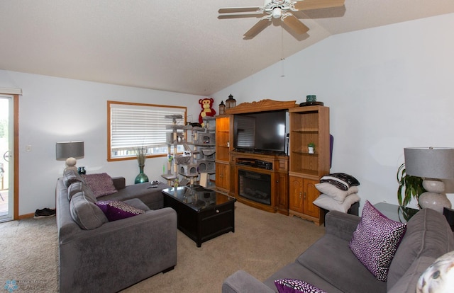 carpeted living room with ceiling fan, plenty of natural light, and vaulted ceiling