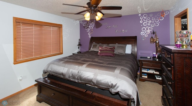 bedroom featuring a textured ceiling, light carpet, and ceiling fan