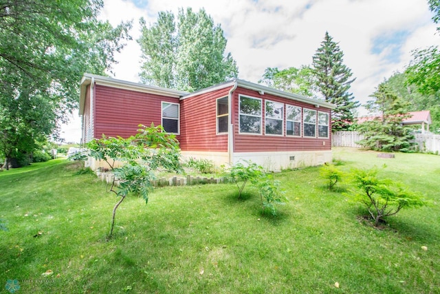 rear view of house with a lawn