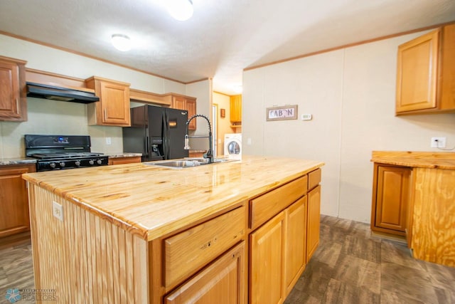 kitchen with dark hardwood / wood-style flooring, black fridge, butcher block counters, stove, and a center island with sink