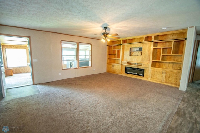 unfurnished living room featuring a wealth of natural light, ceiling fan, and light carpet